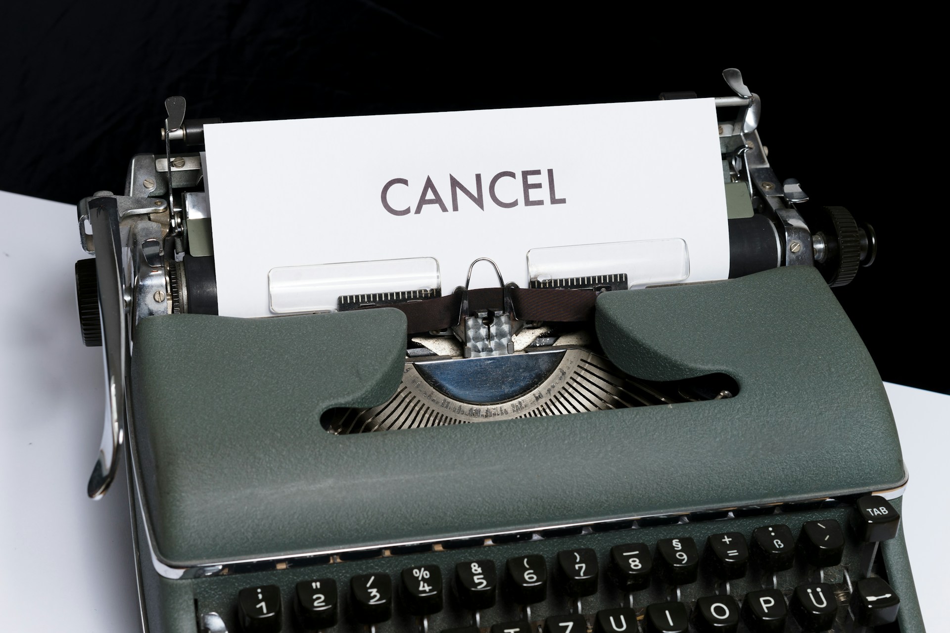 Image shows typewriter with "Cancel" typed on paper, demonstrating the desire you may have to remove your book from Amazon.