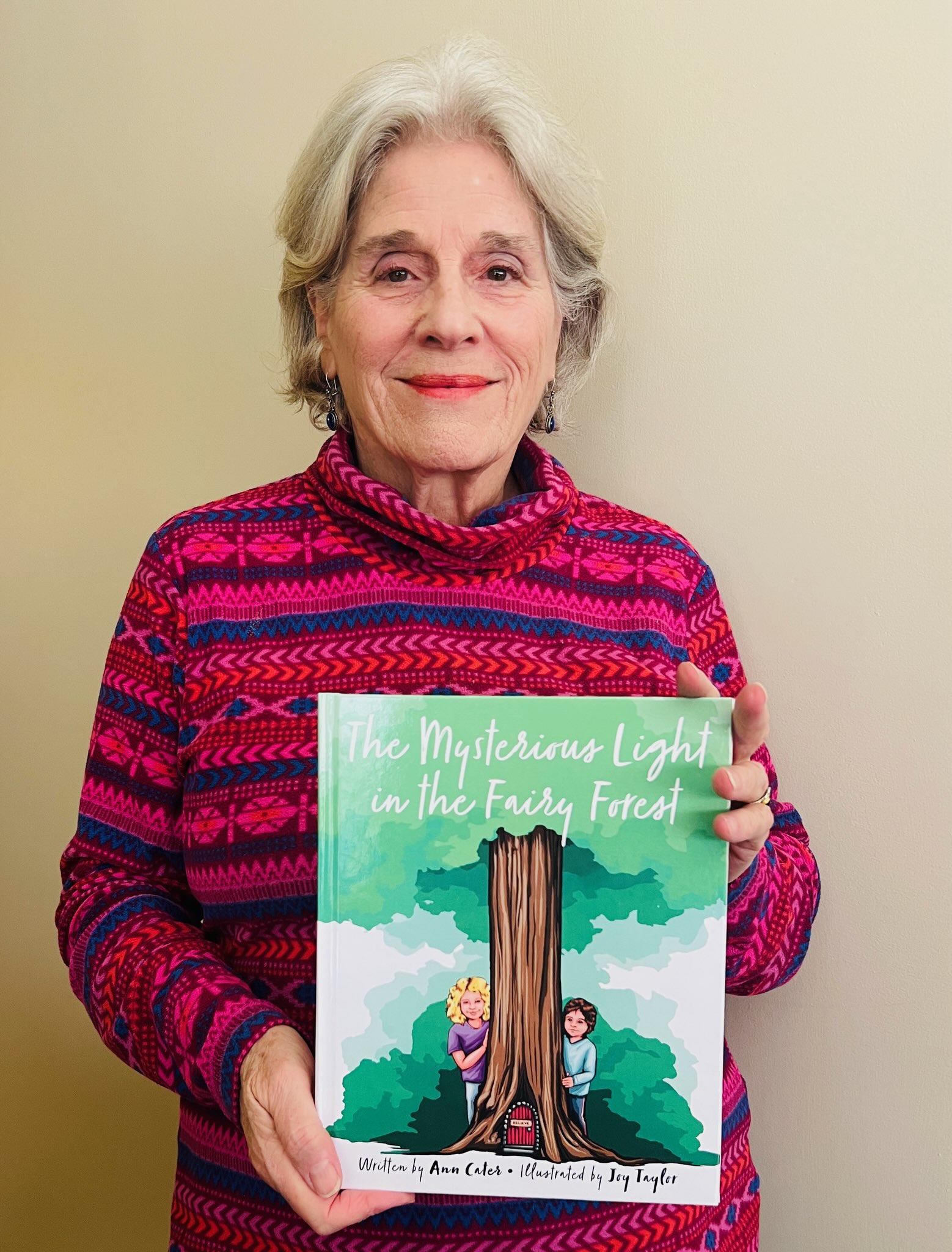 Chattanooga author Ann Cater holds her latest children's picture book, The Mysterious Light in the Fairy Forest, published by Argyle Fox Publishing.