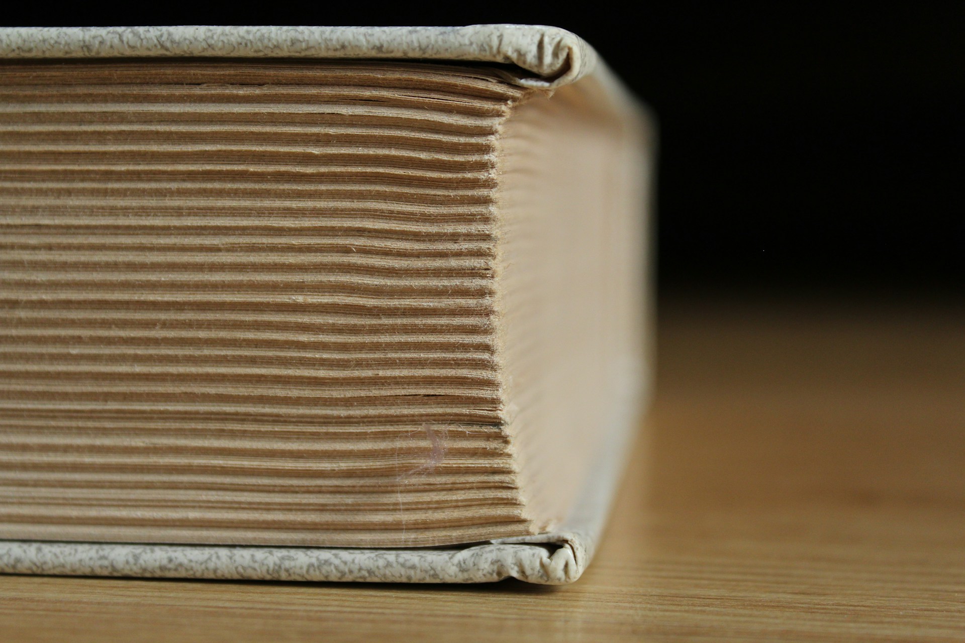 Thick book lying on its side, illustrating the topic, How long should your book be?