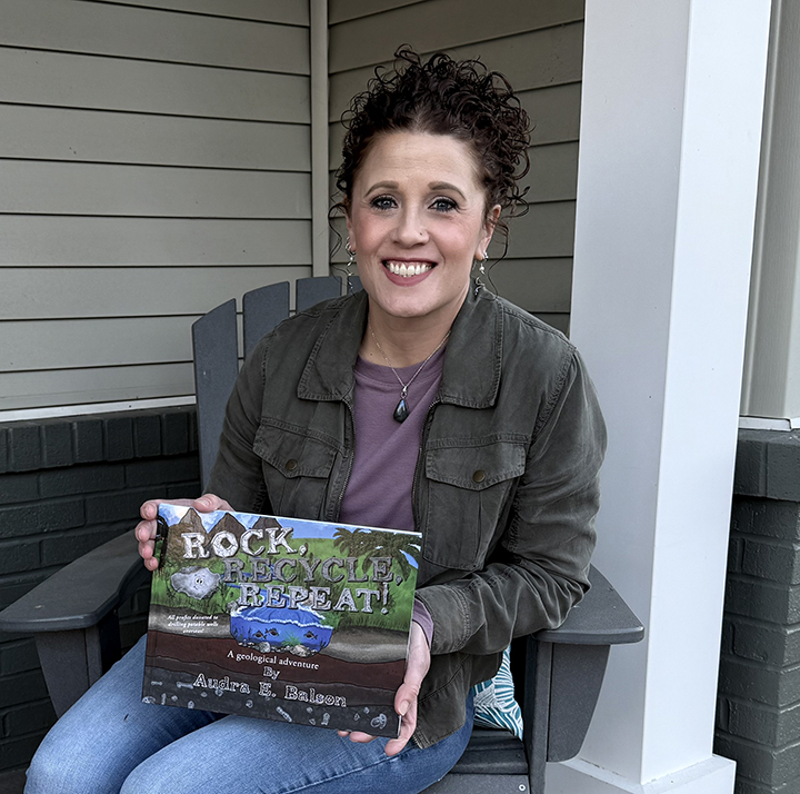 Argyle Fox Publishing author Audra E. Balson holds her first children's book, Rock, Recycle, Repeat!